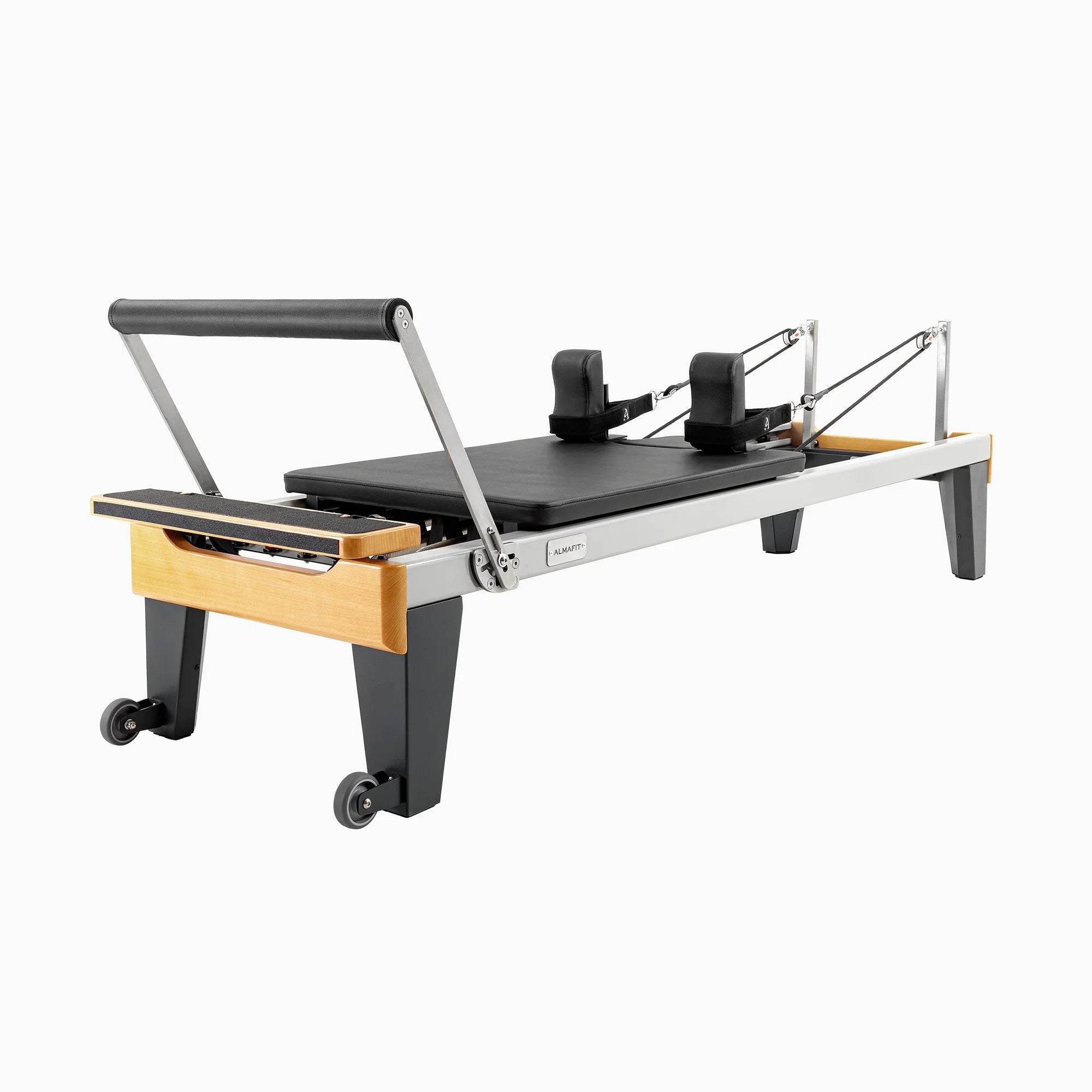 Almafit Aion - a Pilates Reformer machine with gray frame, black mat, and wooden accents, equipped with wheels and foot straps.